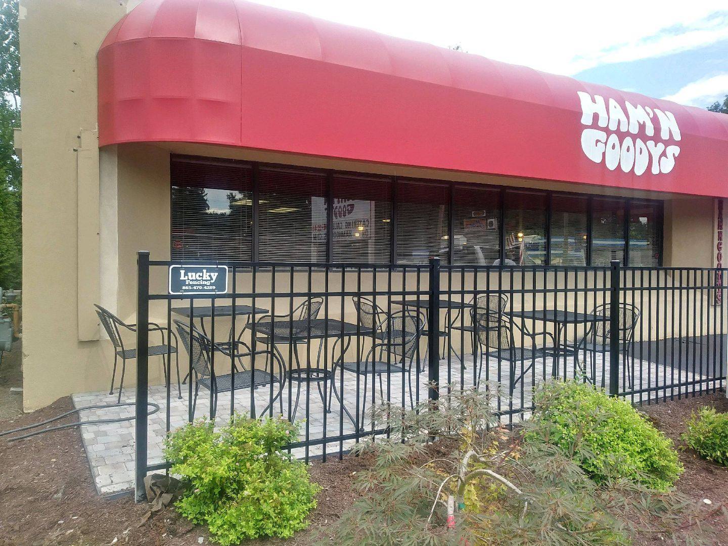 Black aluminum fence around a restaurant's outdoor patio