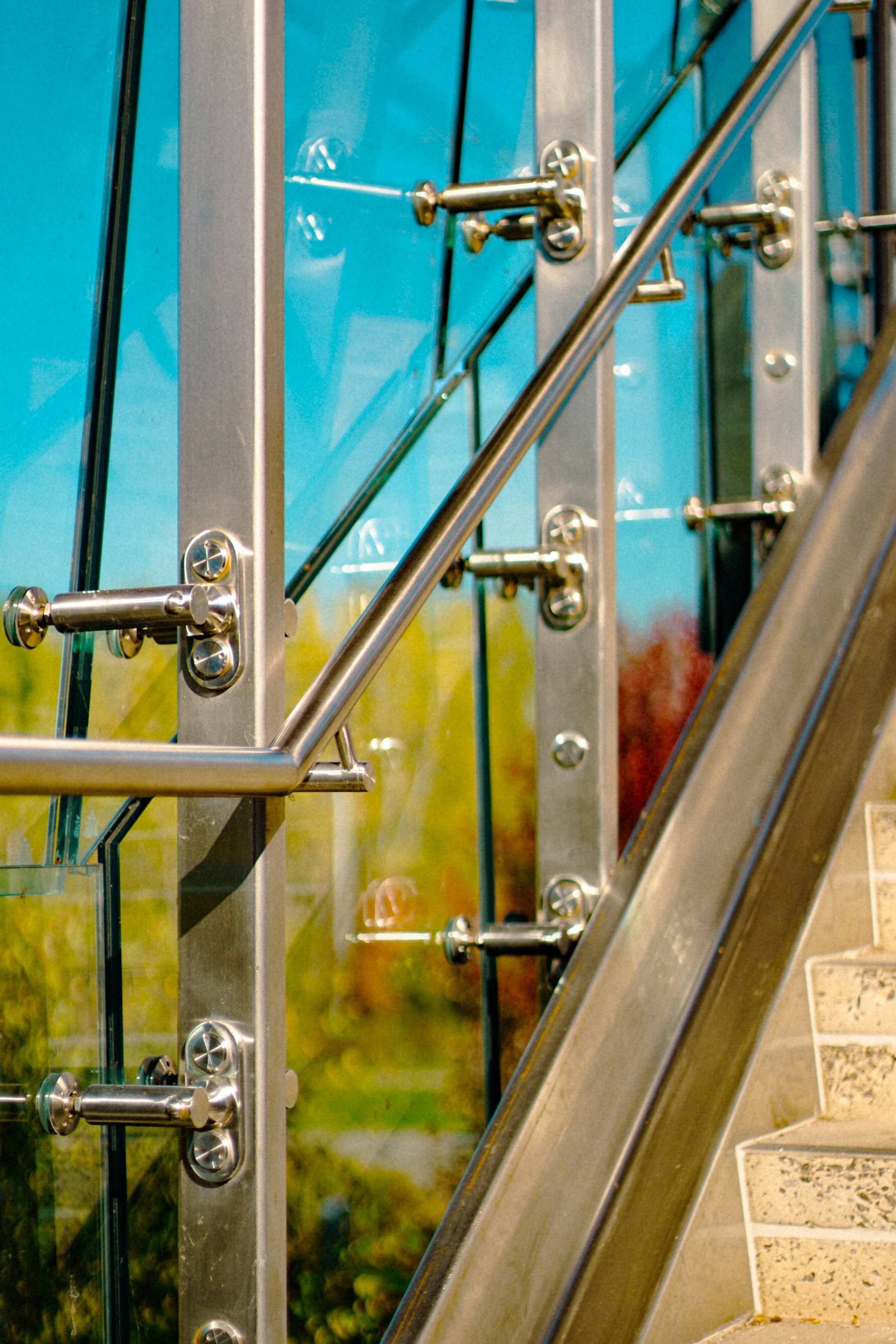 Glass railing panels with stainless steel fittings